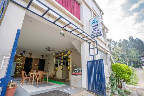 a building with a blue door and a table at Hotel Misty INN in Yercaud