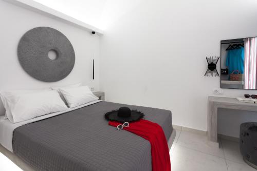 a bedroom with a bed with a red blanket on it at Villa Izabela in Santorini