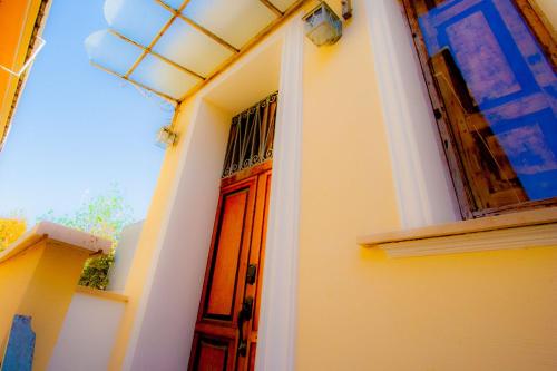 a house with a red door and a window at Old Style by the sea, roof terrace with pool and kitchen, Ladispoli in Ladispoli