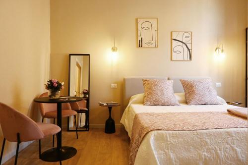 a bedroom with a bed and a table and a mirror at Ta-49 bed e breakfast in Naples