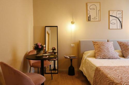 a hotel room with a bed and a table and a mirror at Ta-49 bed e breakfast in Naples