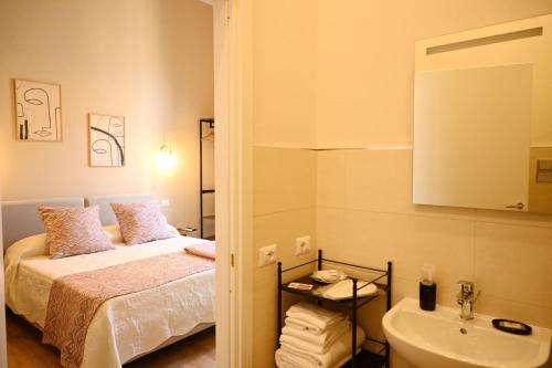 a small bedroom with a bed and a sink at Ta-49 bed e breakfast in Naples