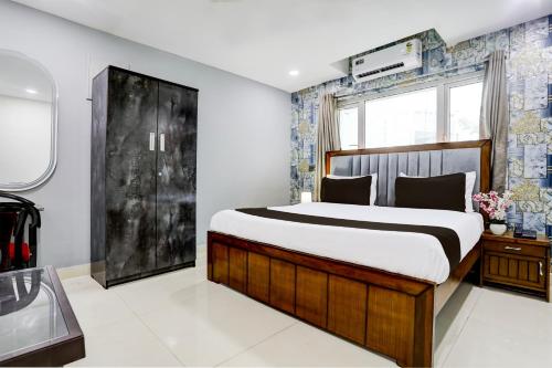 a bedroom with a large bed and a window at Super Townhouse VIP Hills Hitech City in Hyderabad