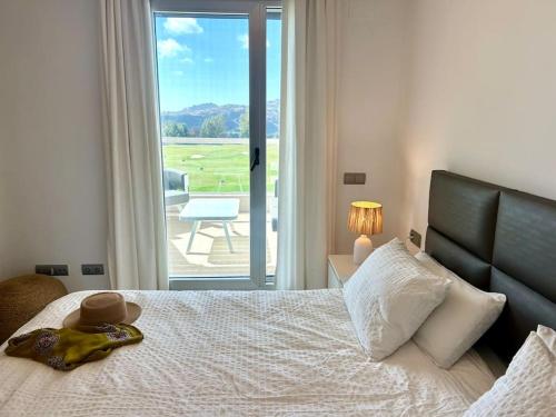 a bedroom with a bed with a view of a patio at Appartement du Bonheur - La Cala Resort in Mijas Costa