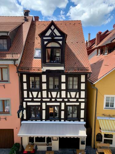 a black and white building with a white awning at Gästehaus AM HAFEN in Meersburg