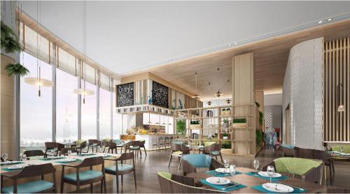 a restaurant with tables and chairs and large windows at EVEN Hotel Nanjing Yangtze River by IHG in Nanjing