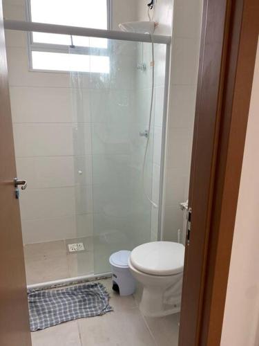 a small bathroom with a toilet and a shower at Cabedelo, lugar especial para você in Cabedelo