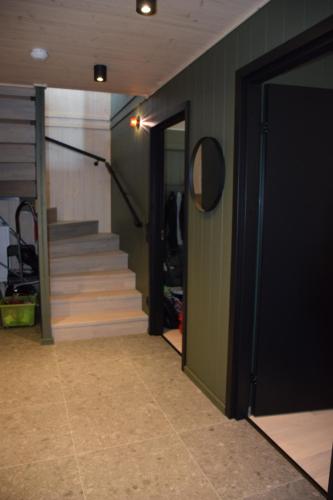 a hallway with stairs and a door leading to a room at Ljungvind Funäsdalen in Funäsdalen