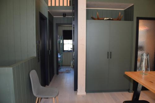 a hallway with a table and a chair in a room at Ljungvind Funäsdalen in Funäsdalen
