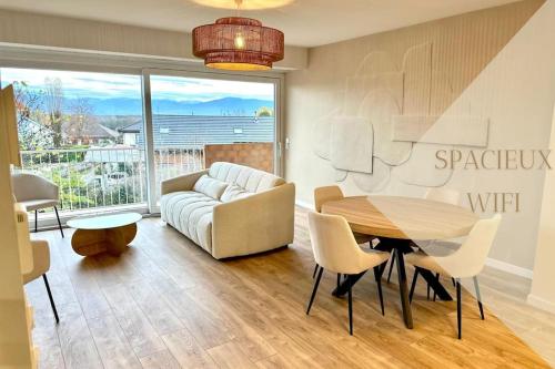a living room with a table and a couch at L'Élégance de Bellevue in Divonne-les-Bains