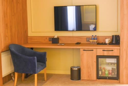 a room with a desk with a television on top at Ulaanbaatar Hotel in Ulaanbaatar