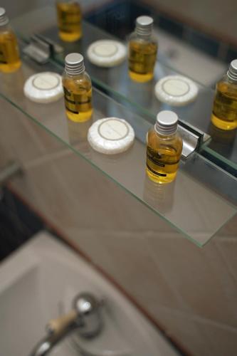 a glass counter top with bottles of honey on it at Vatellis Villas in Patitiri