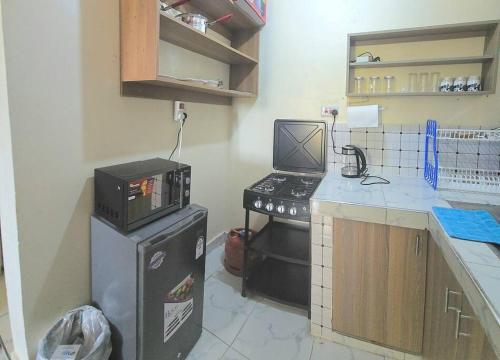 una cocina con estufa y encimera en Mtwapa cosy 1 bed, en Mtwapa
