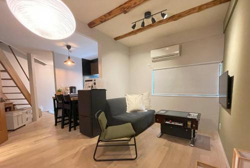 a living room with a couch and a table at Vacation House Tennoji 168 IROHA, Osaka in Osaka