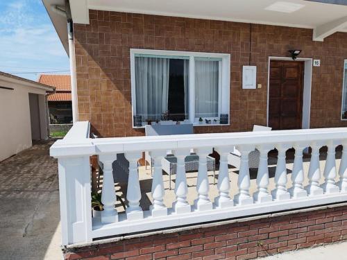 a white railing on a house with a window at Casa en el centro de Bezana in Santa Cruz de Bezana