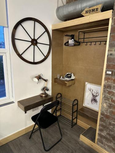 a room with a desk and a wheel on the wall at Renovated Studio - Free Parking - Great Location in Leeds