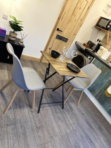 a table and two chairs in a room at Renovated Studio - Free Parking - Great Location in Leeds