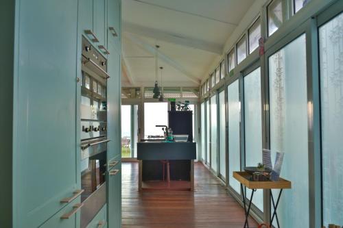 a hallway with glass walls and a kitchen with a counter at Boutique Villa on the Rocks with Stunning Sea Views, Infinity Pool & Private Sea in Trou dʼ Eau Douce