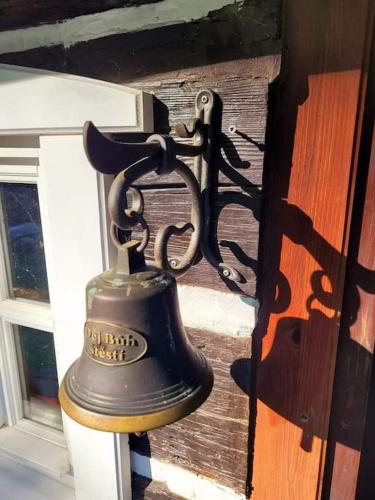 a bell hanging on the side of a door at Roubenka u kapličky in Liberec