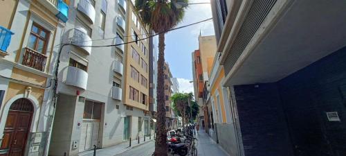 ラスパルマス・デ・グランカナリアにあるJOCA House IV Las Canterasの二棟の間の路地のヤシの木