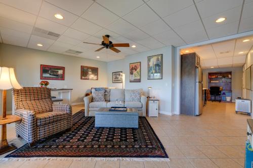 a living room with couches and a ceiling fan at Lake Chatuge Apt with Boat Dock in Hayesville! in Hayesville