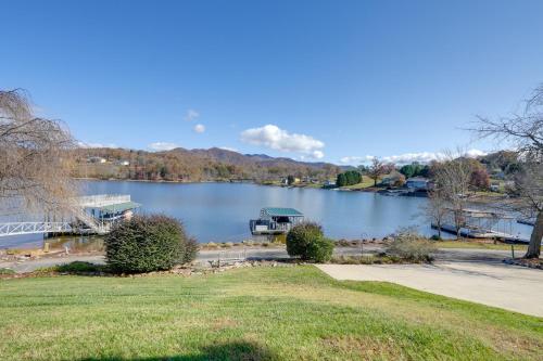 a view of a lake with a house and a dock at Lake Chatuge Apt with Boat Dock in Hayesville! in Hayesville