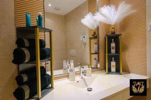 a bathroom with a sink and some bottles of wine at FLH - 777 Apartments in Bucharest