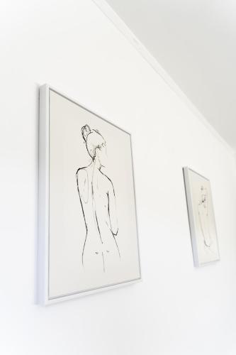 a drawing of a woman in a picture on a wall at Dunbank Apartment in Clydebank