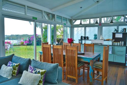 a kitchen and dining room with a table and chairs at Boutique Villa on the Rocks with Stunning Sea Views, Infinity Pool & Private Sea in Trou dʼ Eau Douce