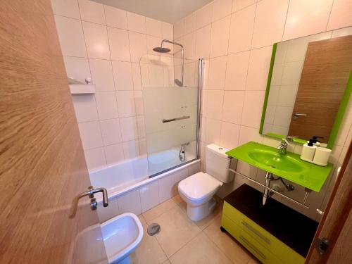 a bathroom with a sink and a toilet and a mirror at Condado De Alhama Naranjos 7 SV99 in El Romero