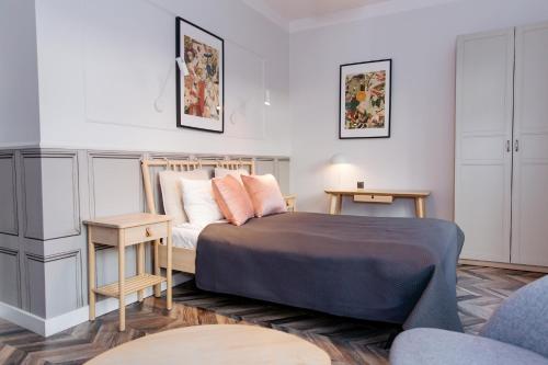 a small bedroom with a bed and a table at Neptunus MB By the Ses Apartments OLD TOWN in Gdańsk