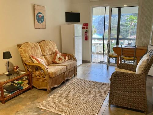 a living room with a couch and a table at Vivenda Linda Vista in Porto da Cruz