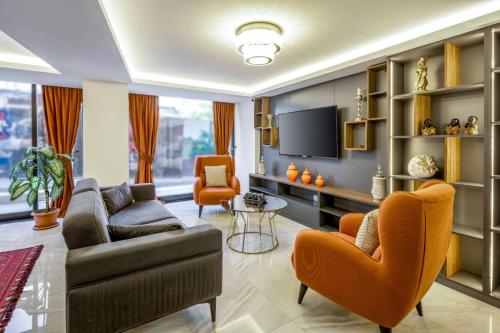 a living room with a couch and chairs and a tv at Diamond Beyazit Hotel in Istanbul
