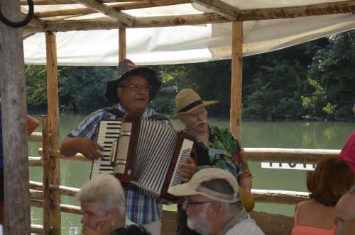 a man playing an accordion in a group of people at Appartementhotel Rutar Lido in Eberndorf