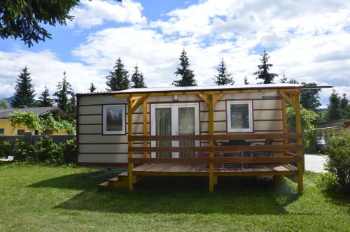a tiny house on the grass in a yard at Appartementhotel Rutar Lido in Eberndorf