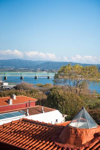 a view of the water from the roof of a house at Viana Rooftop House - Apartment in the historic center with river view in Viana do Castelo