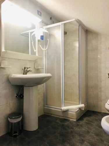a bathroom with a shower and a sink at Hotel Bucaneve in Pescasseroli