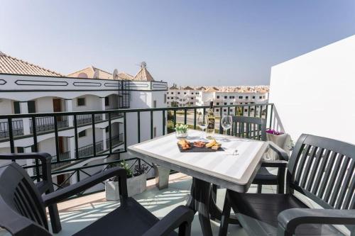 a table and chairs on a balcony with a view at Beachside Golf and City Escape by Lisbeyond in Tavira