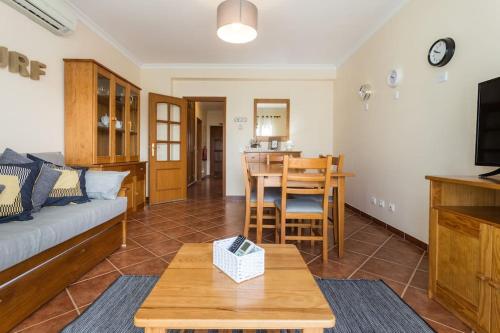 a living room with a couch and a table at Beachside Golf and City Escape by Lisbeyond in Tavira