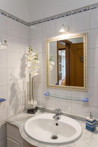 a bathroom with a sink and a mirror at Beachside Golf and City Escape by Lisbeyond in Tavira