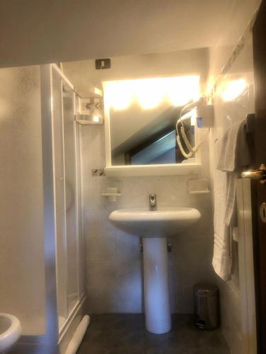 a small bathroom with a sink and a mirror at Hotel Bucaneve in Pescasseroli
