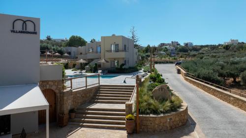 a view of a house with a swimming pool and stairs at Villaggio Mare Suites in Kalamaki Chanion