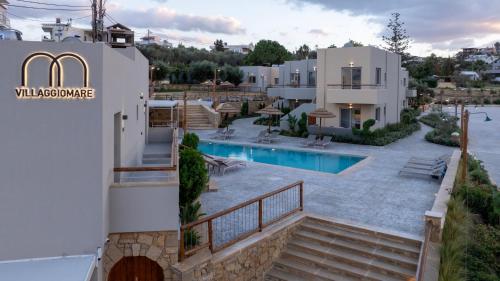 a view of a house with a swimming pool at Villaggio Mare Suites in Kalamaki Chanion