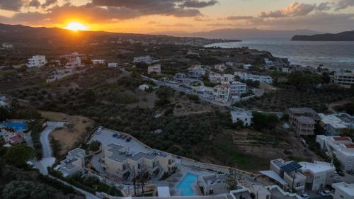 an aerial view of a city with the sunset at Villaggio Mare Suites in Kalamaki Chanion