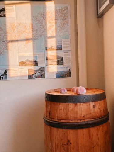 a wooden barrel with two balls on top of it at Finnholmen Brygge in Henningsvær