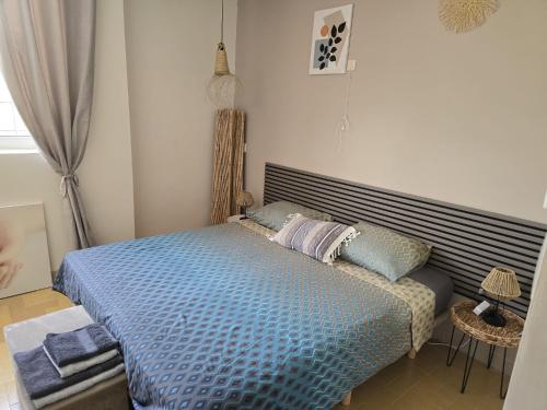 a bedroom with a bed with a blue comforter at Casa en Finca Rustica in Jijona
