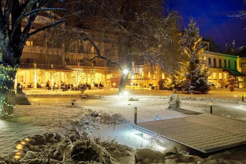 a city square covered in snow at night at Das Parkhotel in Bad Wörishofen