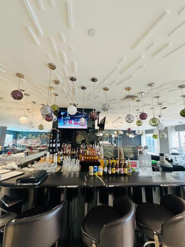 a bar in a restaurant with a counter and chairs at Hotel Residences near Makati in Manila