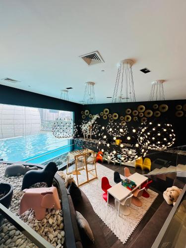 a room with a swimming pool and a room with furniture at Hotel Residences near Makati in Manila