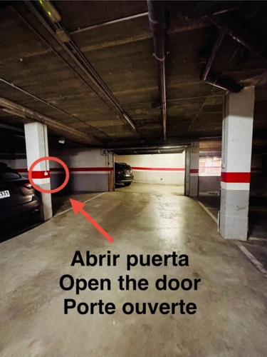 an empty parking garage with a red arrow in it at APARTAMENTO CANILLO Wifi-Parquing free-Terraza HUT 5213 in Canillo